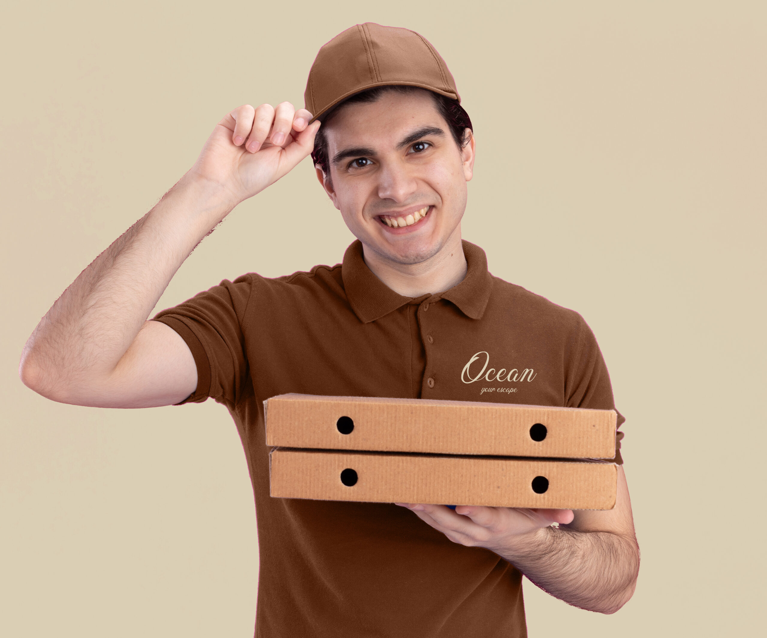 smiling young caucasian delivery man blue uniform cap grabbing his cap holding pizza packages isolated pink wall scaled
